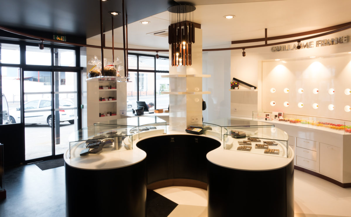Pâtisserie Guillaume France à Lunel, vitrine réfrigérée en demi cercle, exposition chocolat et macaron, boutique conçue par l'agence de design frvr.